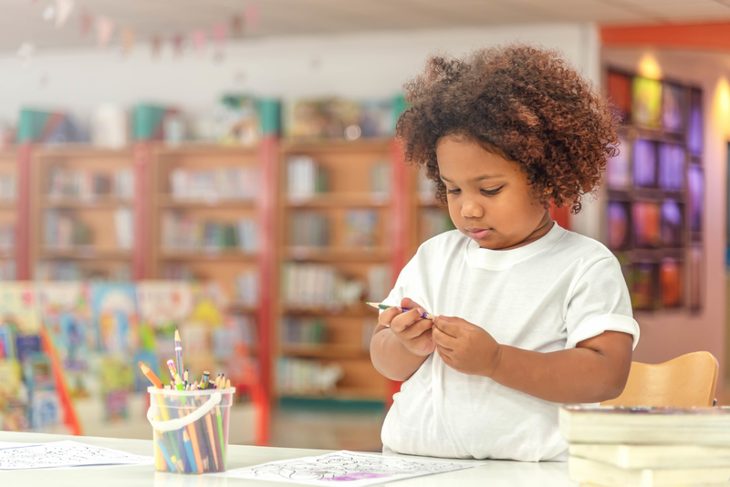 Little toddler girl concentrate on drawing.